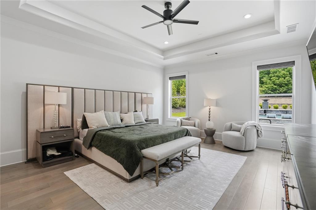 3020 Wallace Road Buford, GA 30519 - Photo 24 of 66 a spacious bedroom with a bed and ceiling fan