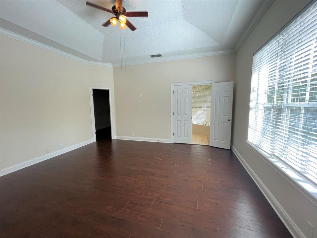 8447 Bowden Way Windermere, FL 34786 - Photo 14 of 21 wooden floor in an empty room with a window