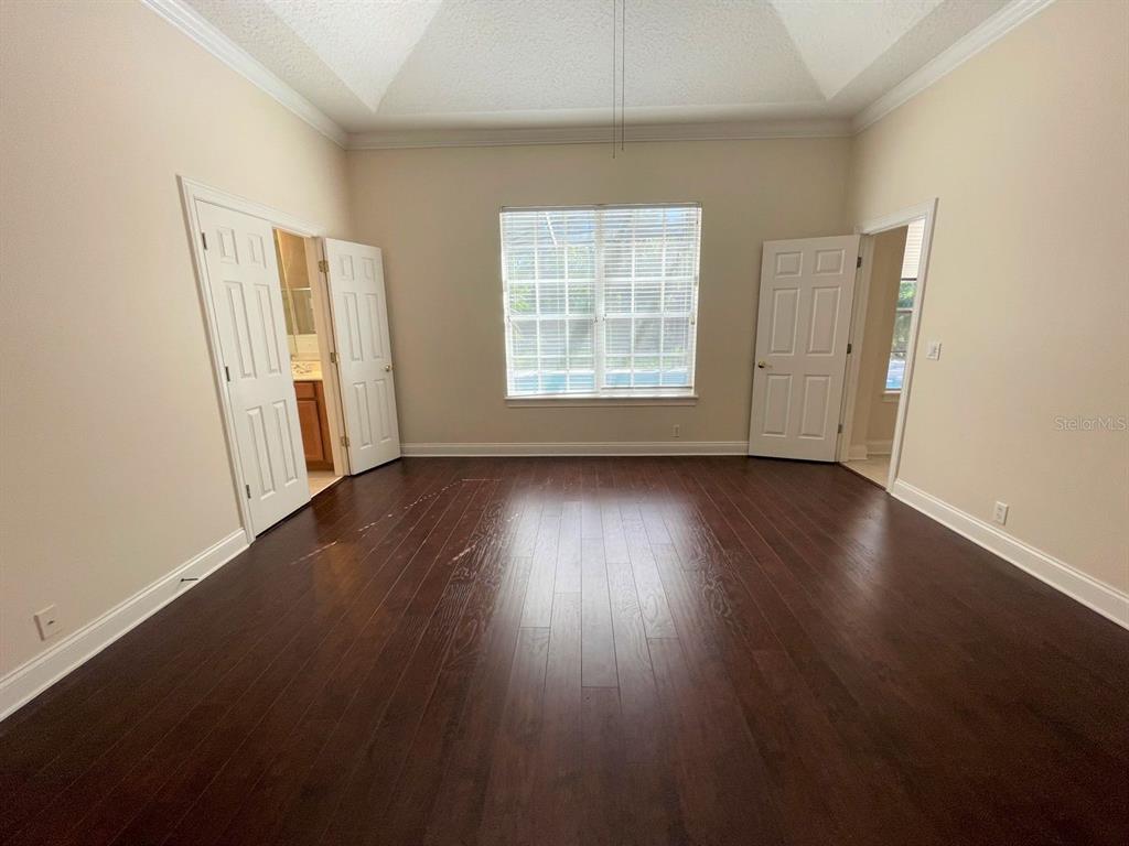 8447 Bowden Way Windermere, FL 34786 - Photo 15 of 21 an empty room with wooden floor and windows