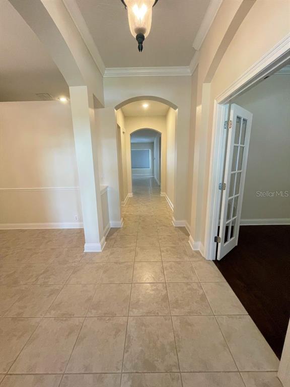 8447 Bowden Way Windermere, FL 34786 - Photo 2 of 21 a view of a hallway with wooden floor and a fireplace