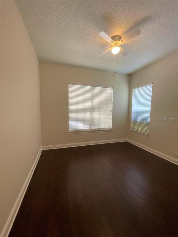 8447 Bowden Way Windermere, FL 34786 - Photo 9 of 21 a view of an empty room with wooden floor and a window