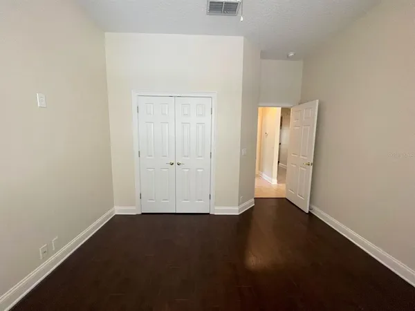 an empty room with wooden floor