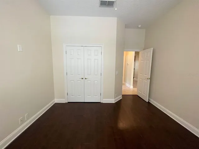 an empty room with wooden floor