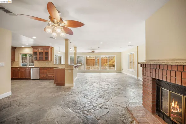 a view of a kitchen with a sink and a fireplace