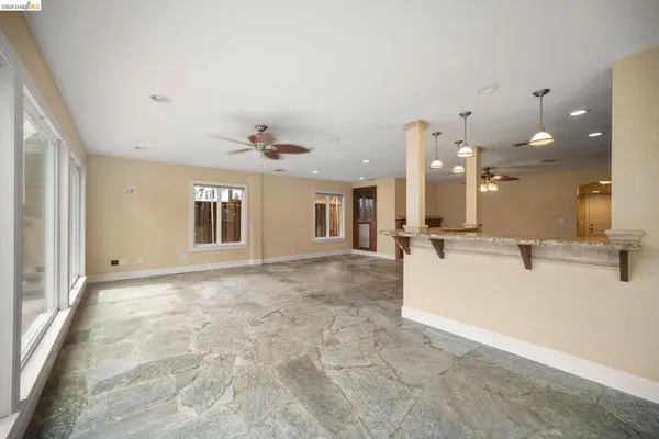 a view of a kitchen with a sink and living room view