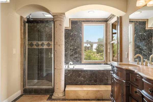 a spacious bathroom with a shower sink and mirror