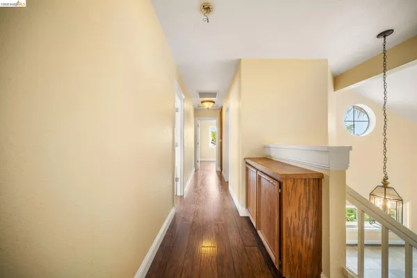 a view of a room with wooden floor closet and windows