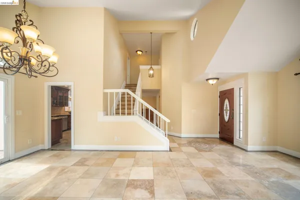 a view of a hallway with wooden floor and stairs