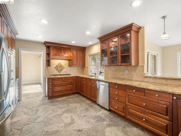 a bathroom with a granite countertop sink mirror and bathtub