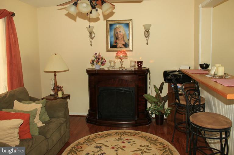 96 Yew Road Baltimore, MD 21221 - Photo 19 of 25 a living room with furniture and a fireplace