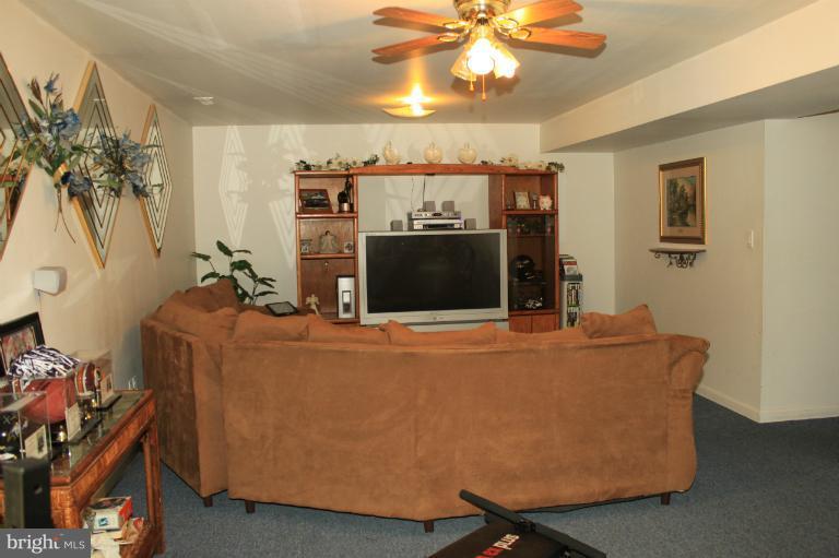 96 Yew Road Baltimore, MD 21221 - Photo 21 of 25 a living room with furniture and a flat screen tv