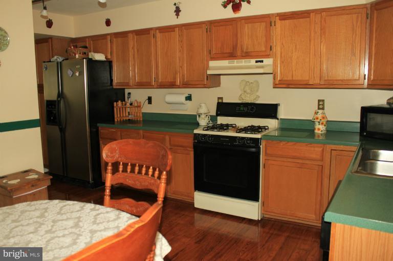 96 Yew Road Baltimore, MD 21221 - Photo 22 of 25 a kitchen with granite countertop a stove top oven and cabinets