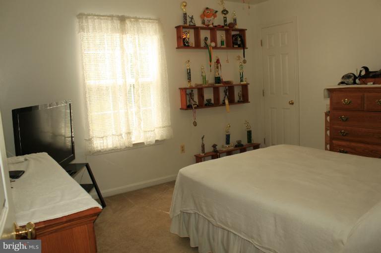 96 Yew Road Baltimore, MD 21221 - Photo 25 of 25 a bedroom with a bed and a dresser in it