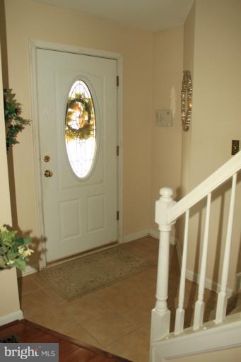 96 Yew Road Baltimore, MD 21221 - Photo 9 of 25 a view of a hallway with wooden floor and a potted plant