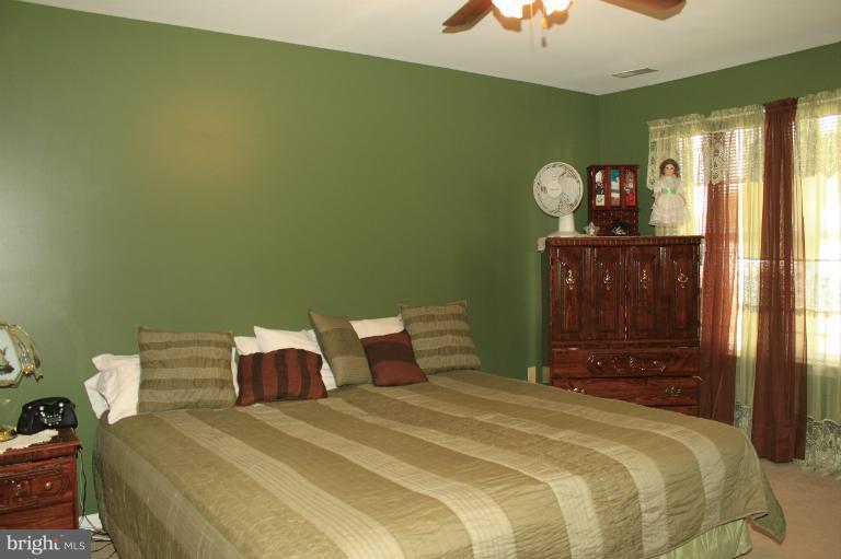 96 Yew Road Baltimore, MD 21221 - Photo 10 of 25 a bedroom with a bed and a chandelier