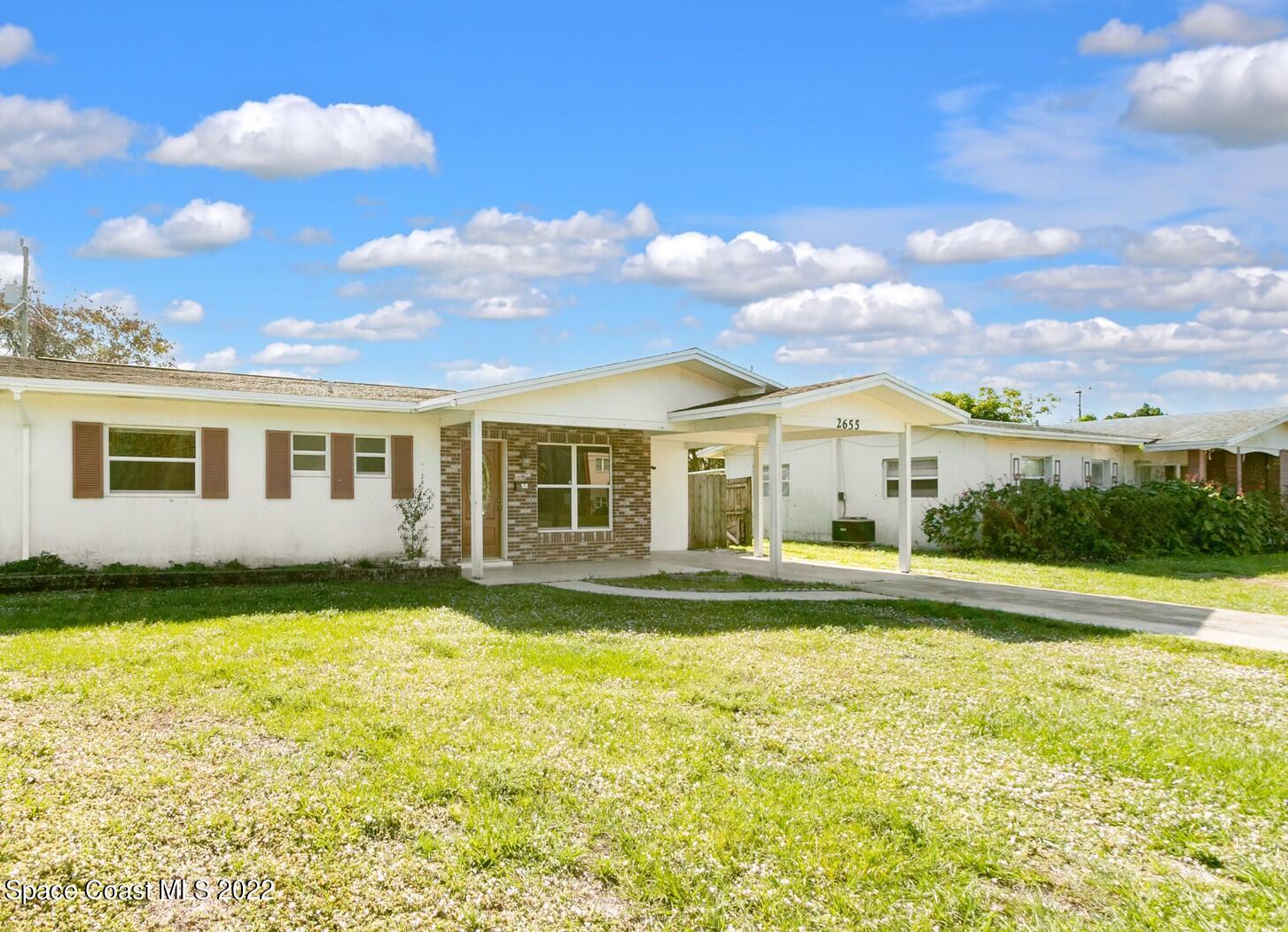 2655 Sarno Road Melbourne, FL 32935 - Photo 1 of 18 a view of a house with a swimming pool and a yard