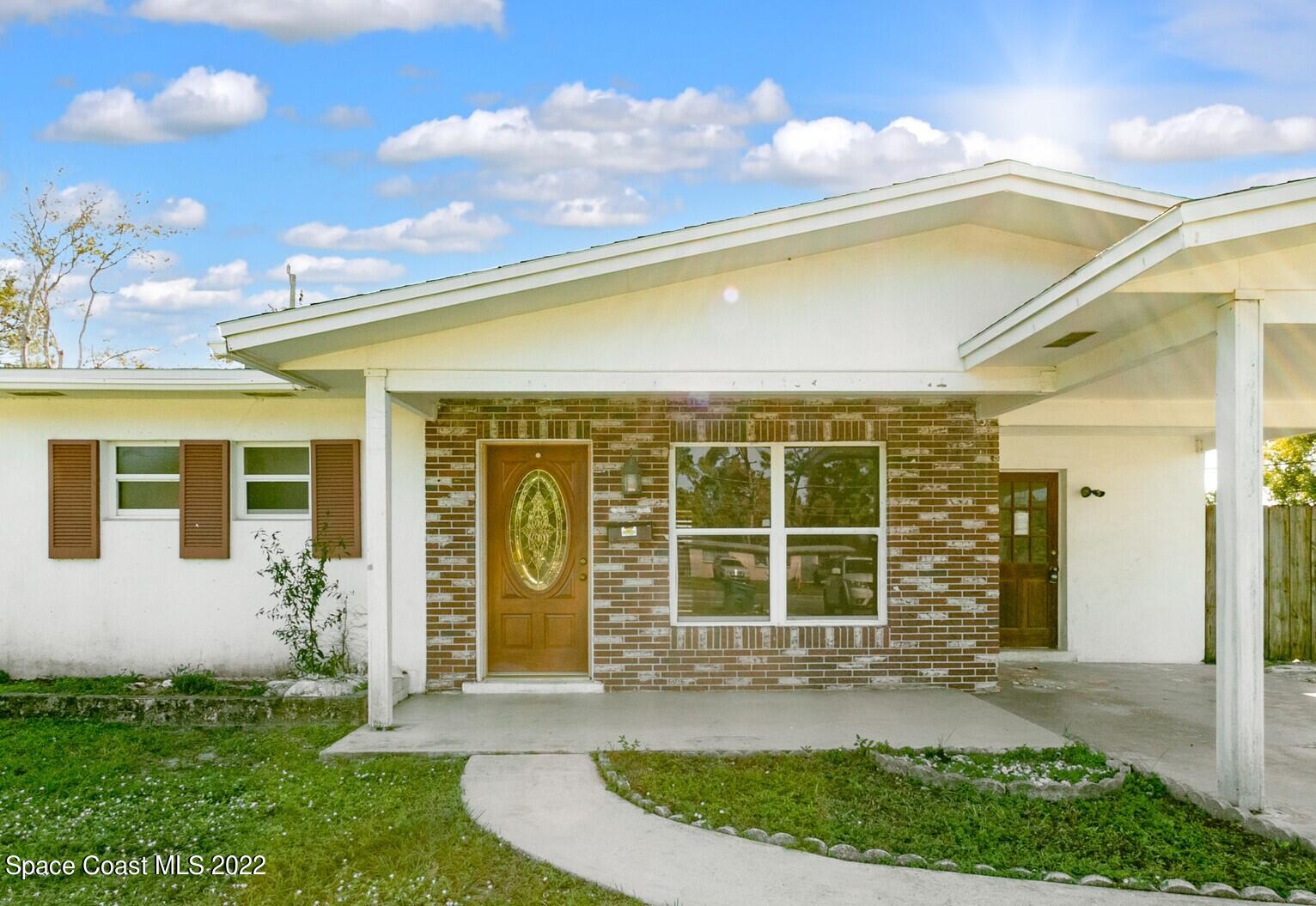 2655 Sarno Road Melbourne, FL 32935 - Photo 2 of 18 a front view of a house with a yard