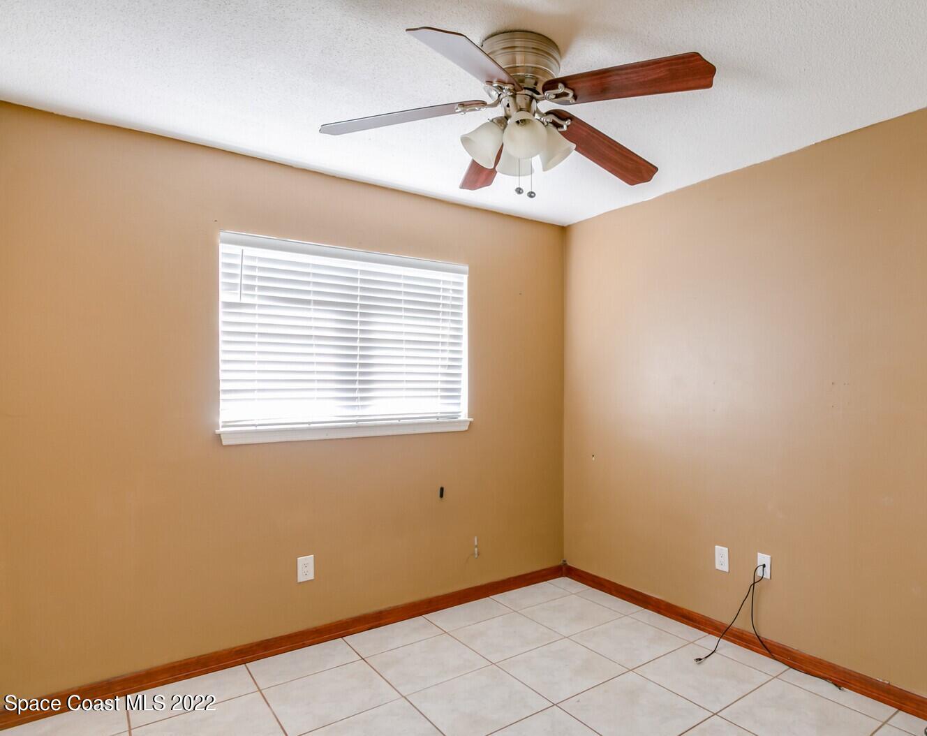 2655 Sarno Road Melbourne, FL 32935 - Photo 8 of 18 a view of an empty room with a window