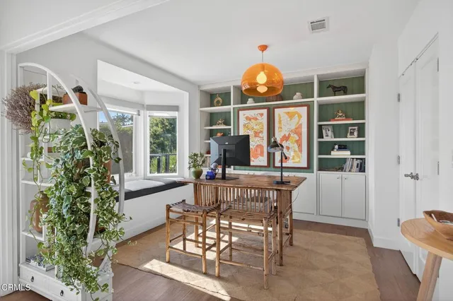 a kitchen filled with white cabinets and white appliances