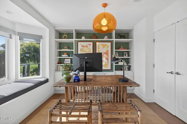 a kitchen with a stove a table and chairs in it