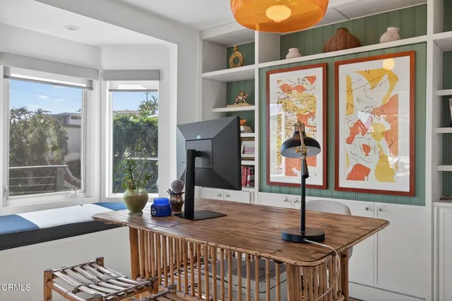 a kitchen with white cabinets and sink
