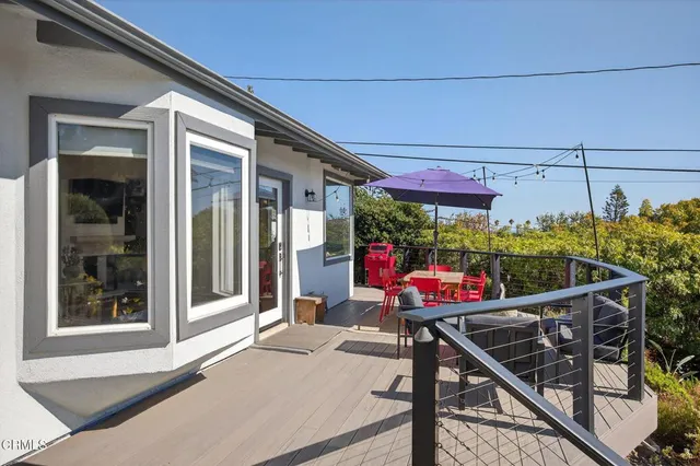 a patio with a table and chairs under an umbrella