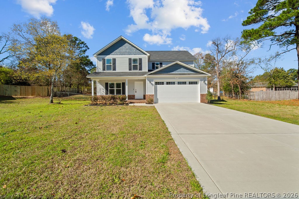 6915 Wickersham Road Fayetteville, NC 28314 - Photo 1 of 25 a front view of a house with a yard