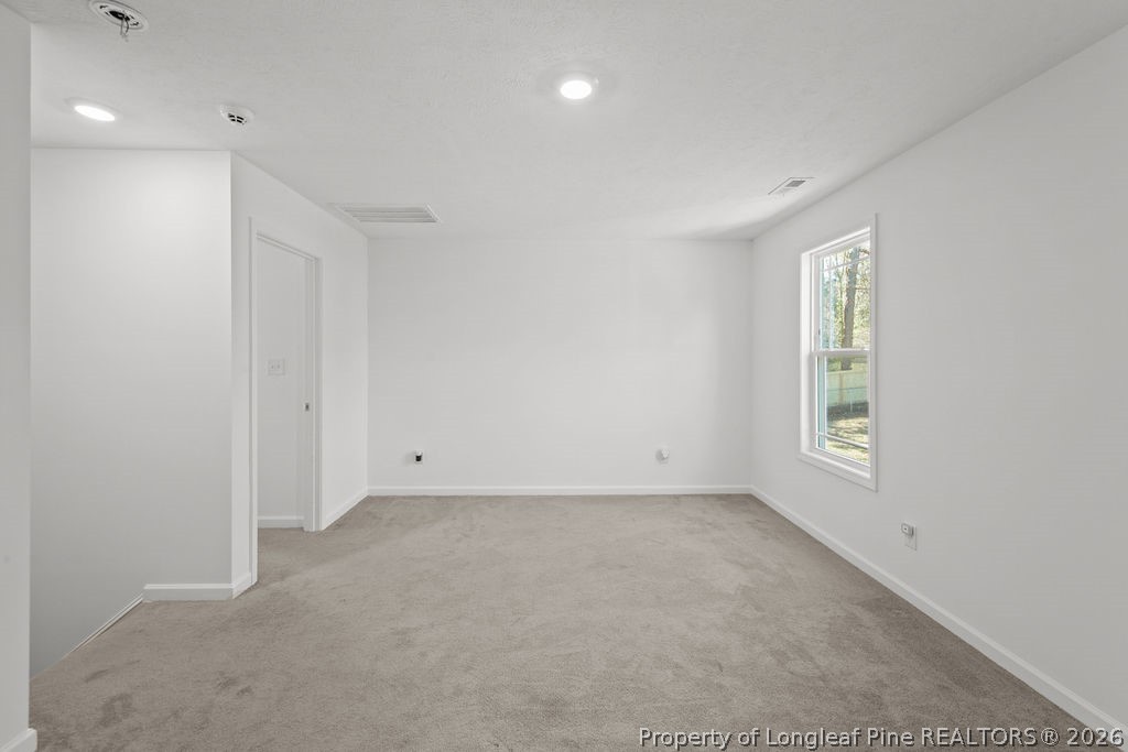 6915 Wickersham Road Fayetteville, NC 28314 - Photo 11 of 25 an empty room with windows