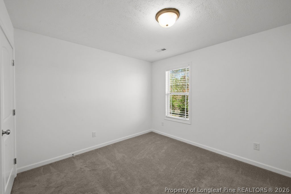6915 Wickersham Road Fayetteville, NC 28314 - Photo 13 of 25 an empty room with a window