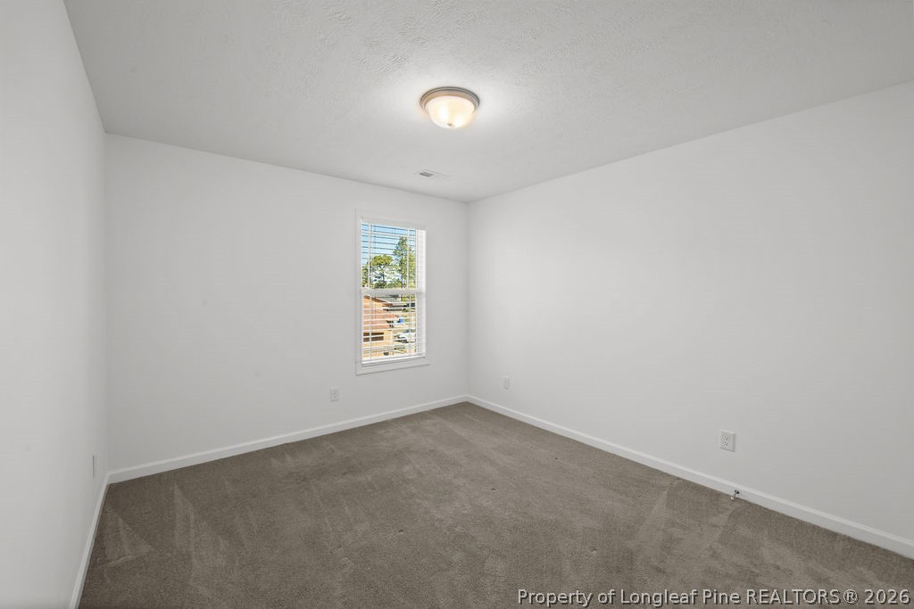 6915 Wickersham Road Fayetteville, NC 28314 - Photo 15 of 25 a view of an empty room with a window