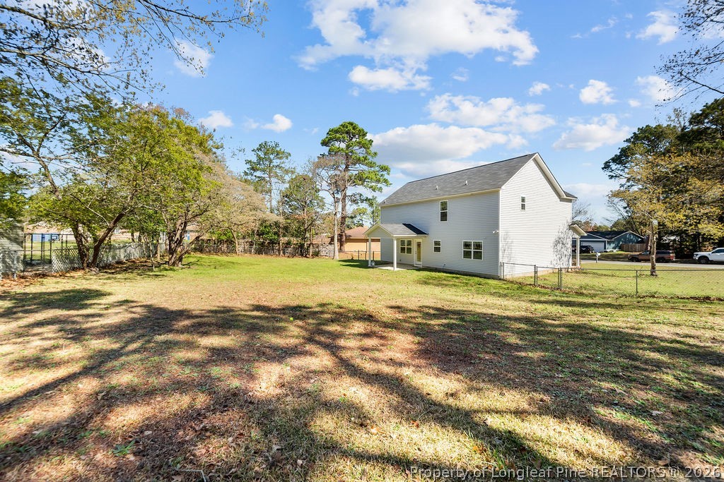 6915 Wickersham Road Fayetteville, NC 28314 - Photo 24 of 25 a view of a house with a yard