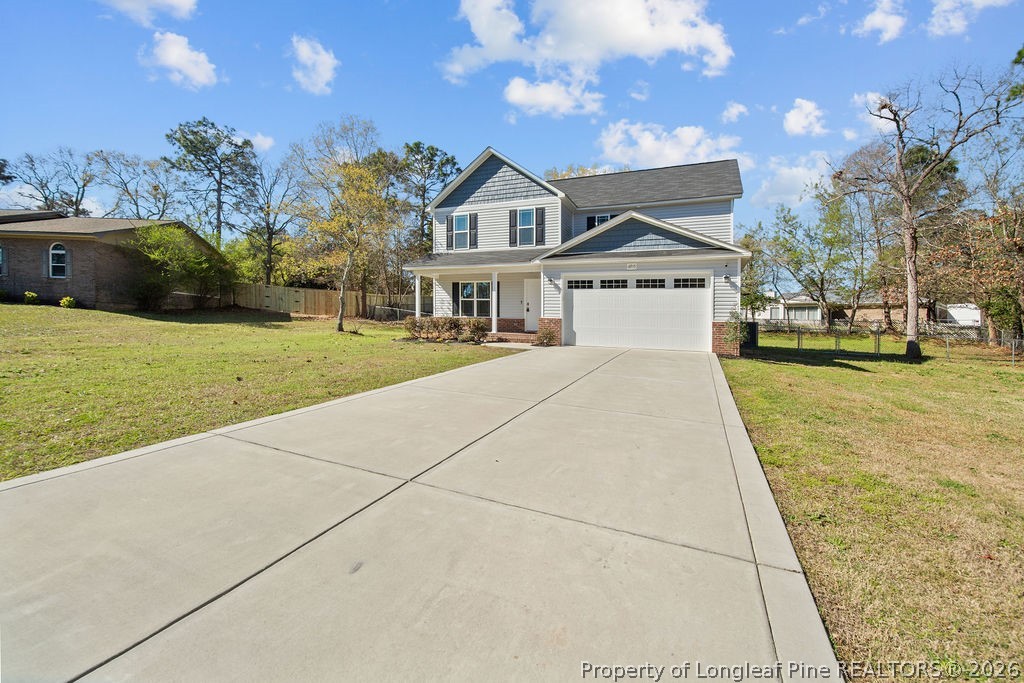 6915 Wickersham Road Fayetteville, NC 28314 - Photo 25 of 25 a front view of a house with a garden and yard