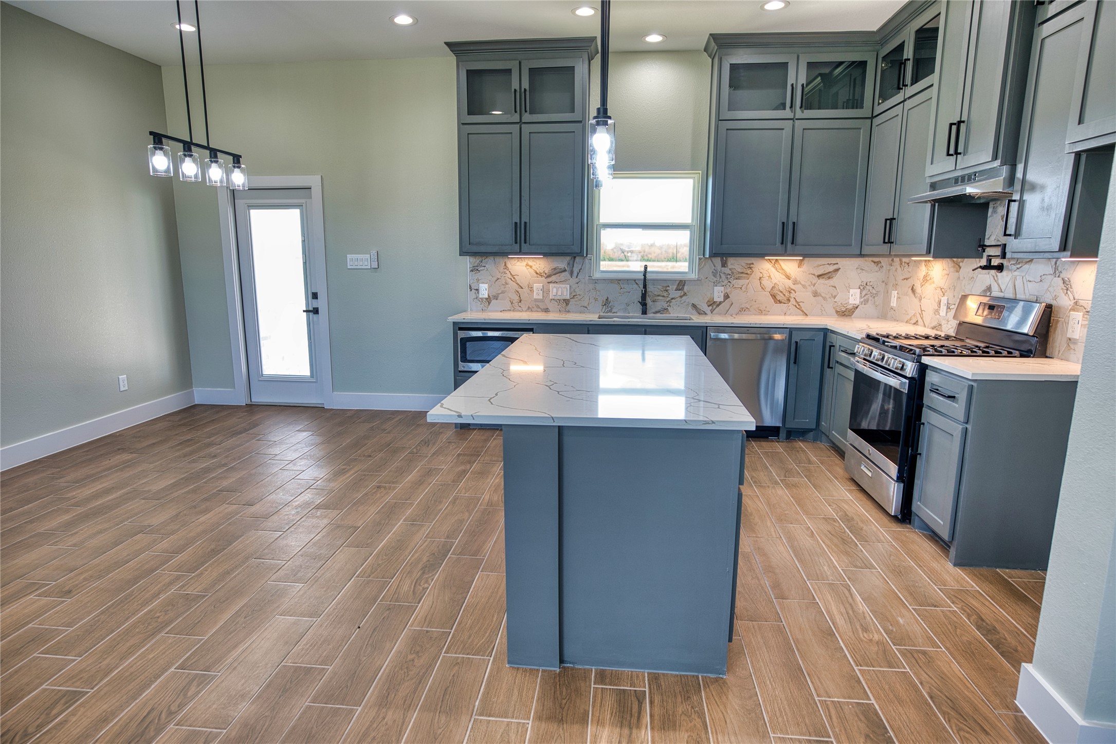 925 Buffalo Trail Angleton, TX 77515 - Photo 19 of 45 a kitchen with stainless steel appliances granite countertop a sink a stove top oven a counter space and cabinets