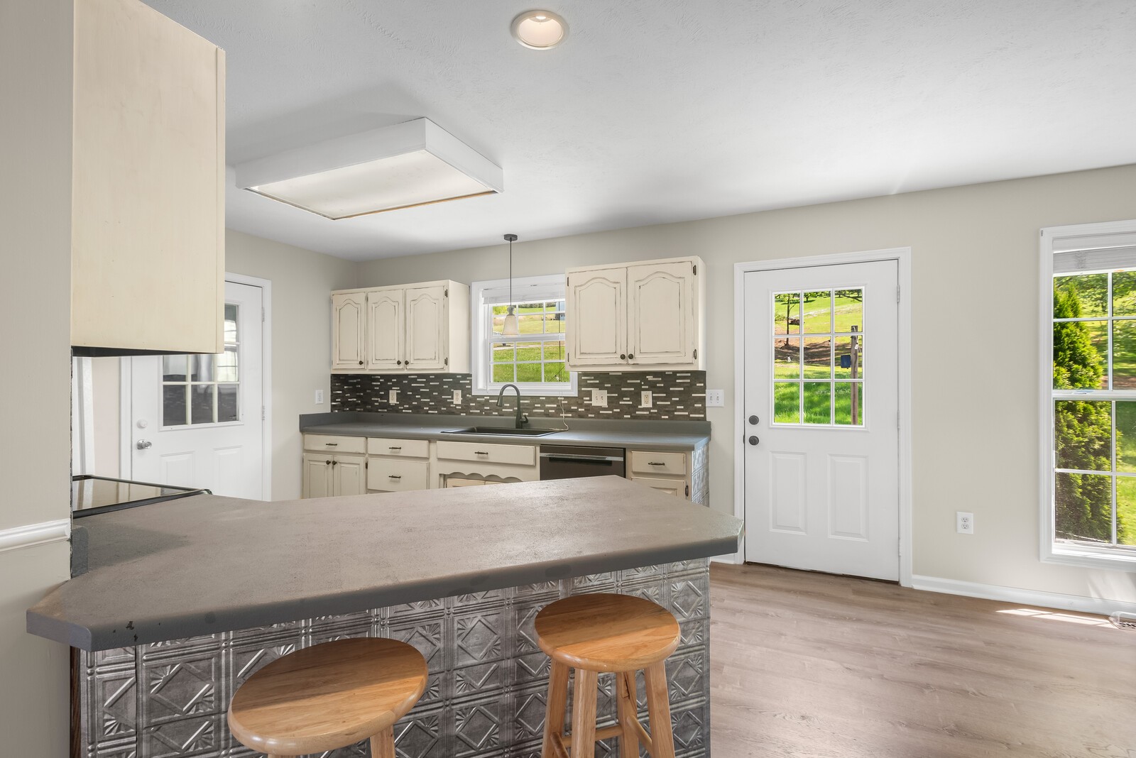 3850 Taylors Store Road Hampshire, TN 38461 - Photo 12 of 57 a kitchen with stainless steel appliances granite countertop a stove a sink a refrigerator white cabinets and wooden floor