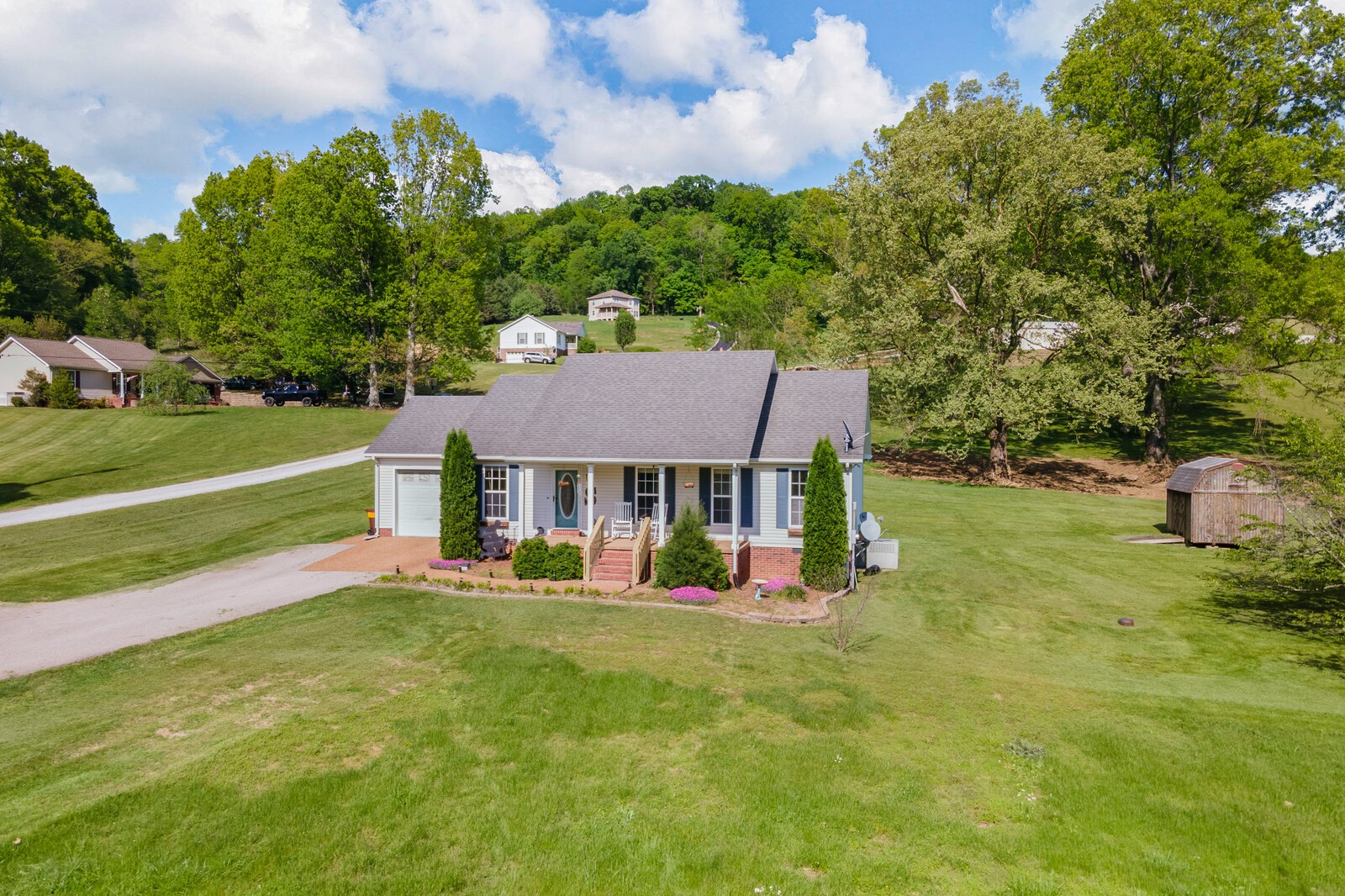 3850 Taylors Store Road Hampshire, TN 38461 - Photo 26 of 57 a view of a house with a big yard potted plants and large tree