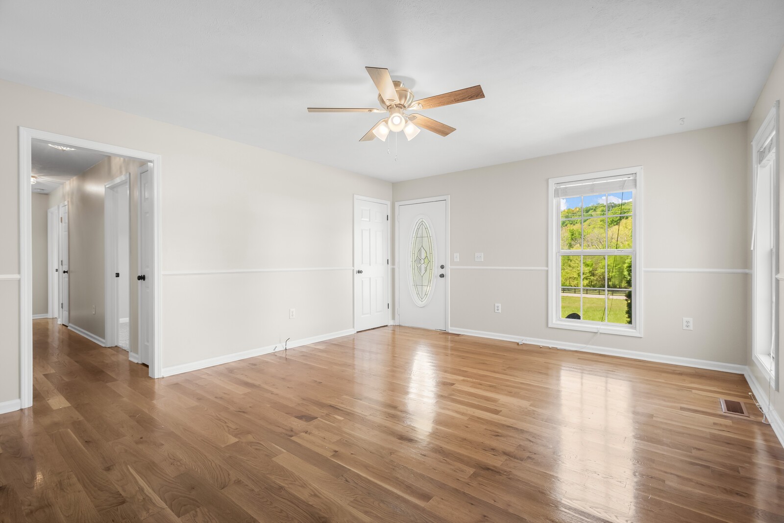 3850 Taylors Store Road Hampshire, TN 38461 - Photo 6 of 57 an empty room with wooden floor window and ceiling fan