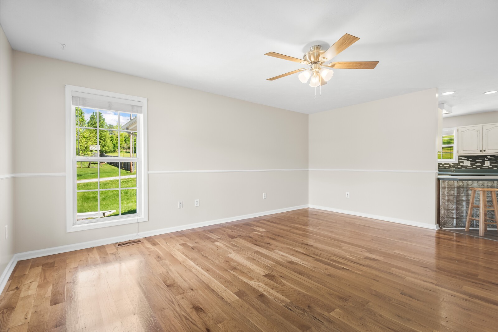 3850 Taylors Store Road Hampshire, TN 38461 - Photo 7 of 57 an empty room with wooden floor fan and windows