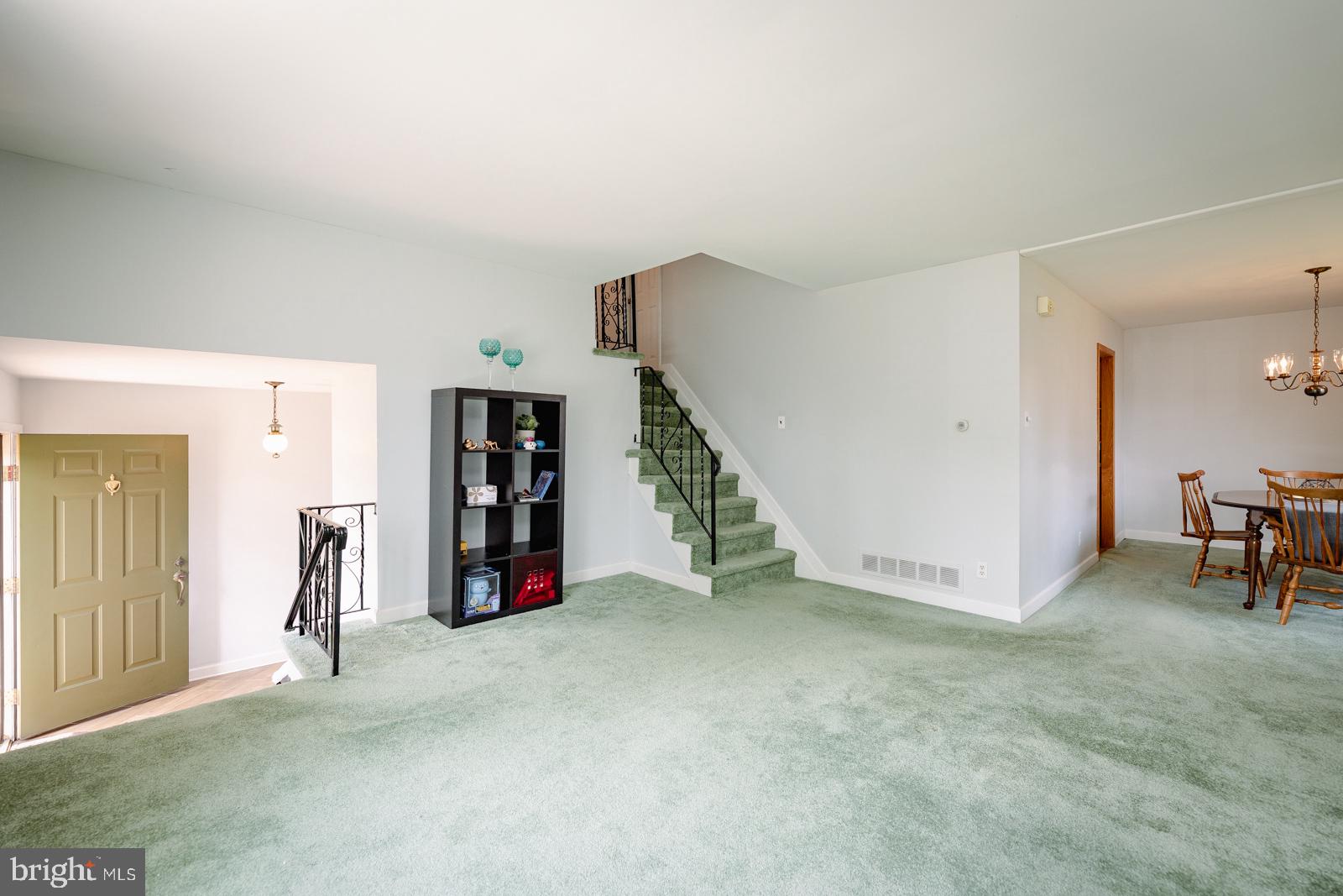 Living Room towards foyer, upstairs & Dining room