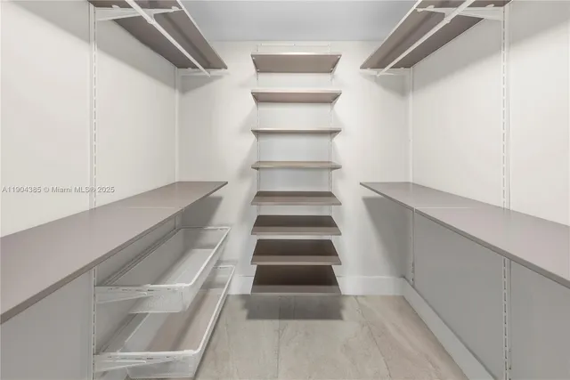 a bathroom with a sink a toilet a mirror and shower