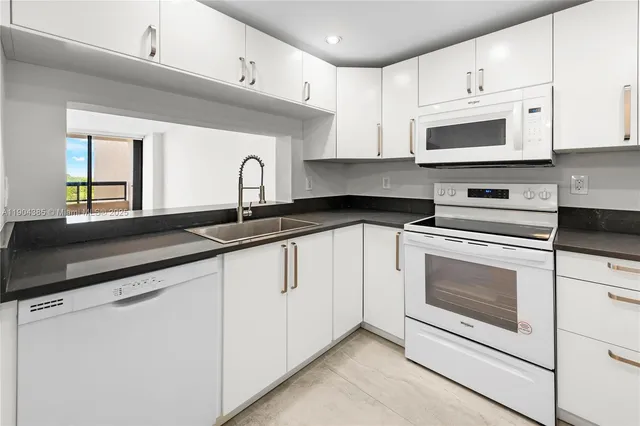 a kitchen with granite countertop a sink and a stove