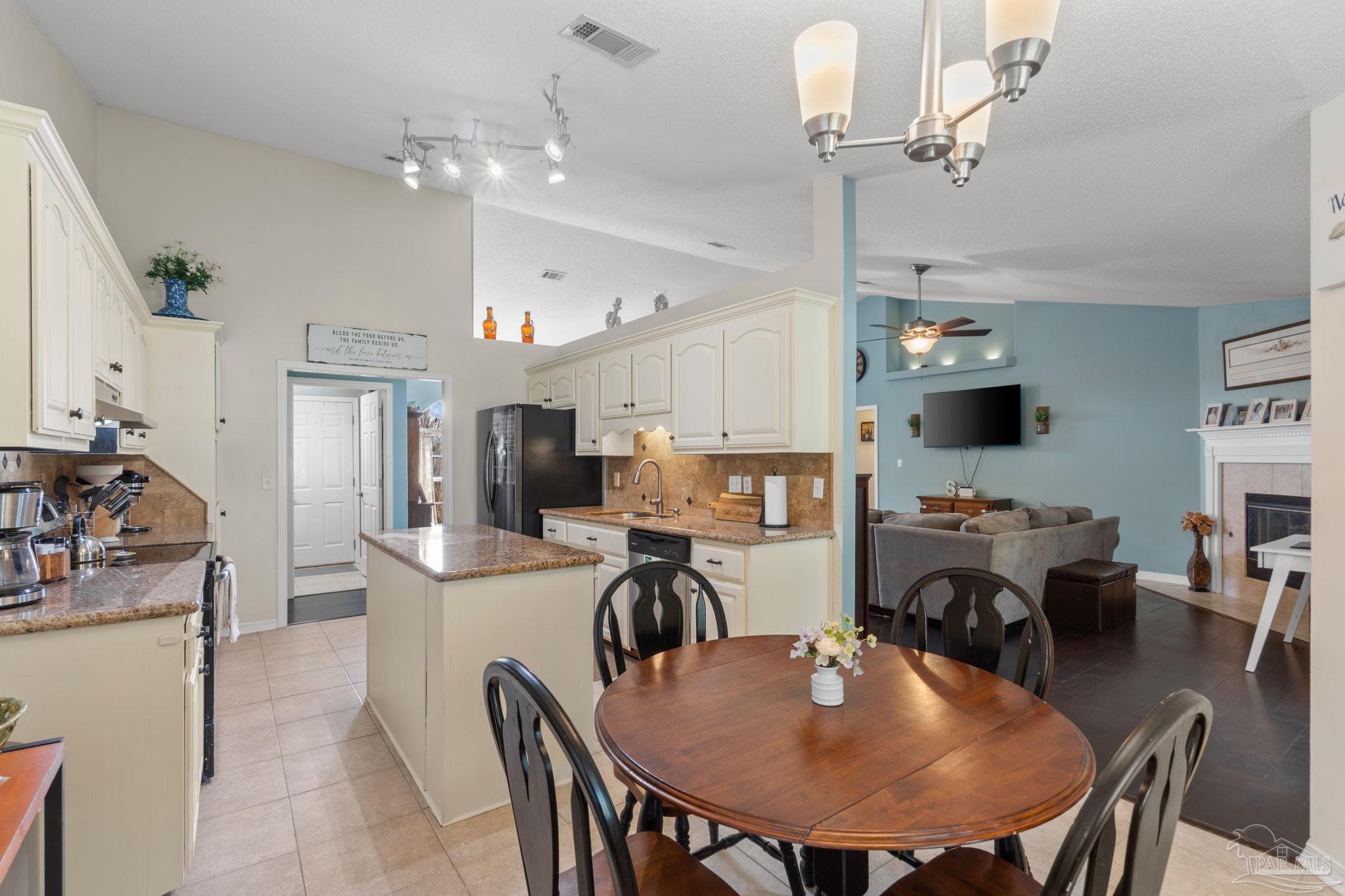 8046 Castle Pointe Way Pensacola, FL 32506 - Photo 11 of 40 a view of a dining room with furniture and a chandelier