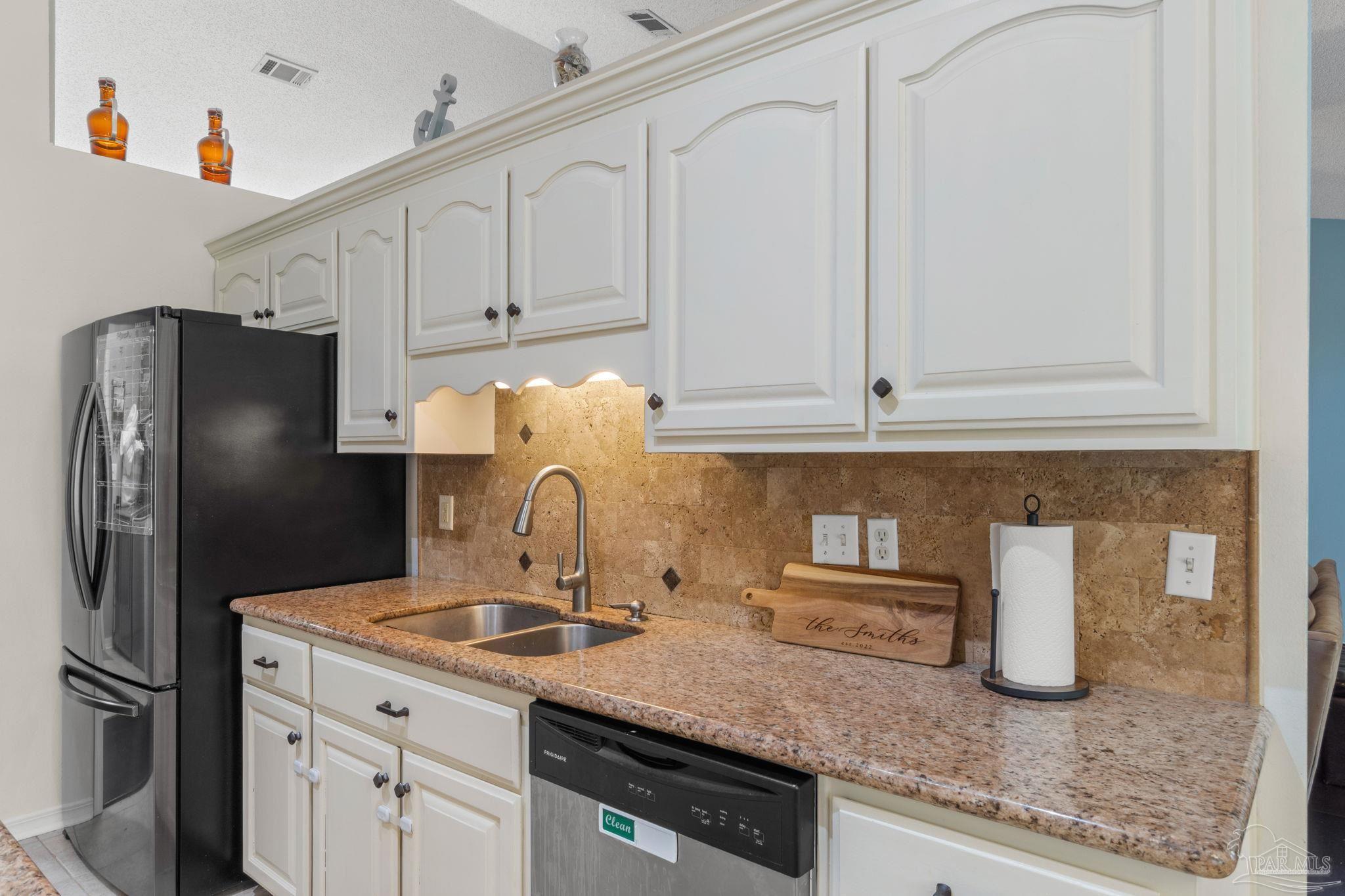 8046 Castle Pointe Way Pensacola, FL 32506 - Photo 14 of 40 a kitchen with granite countertop a refrigerator sink and stove
