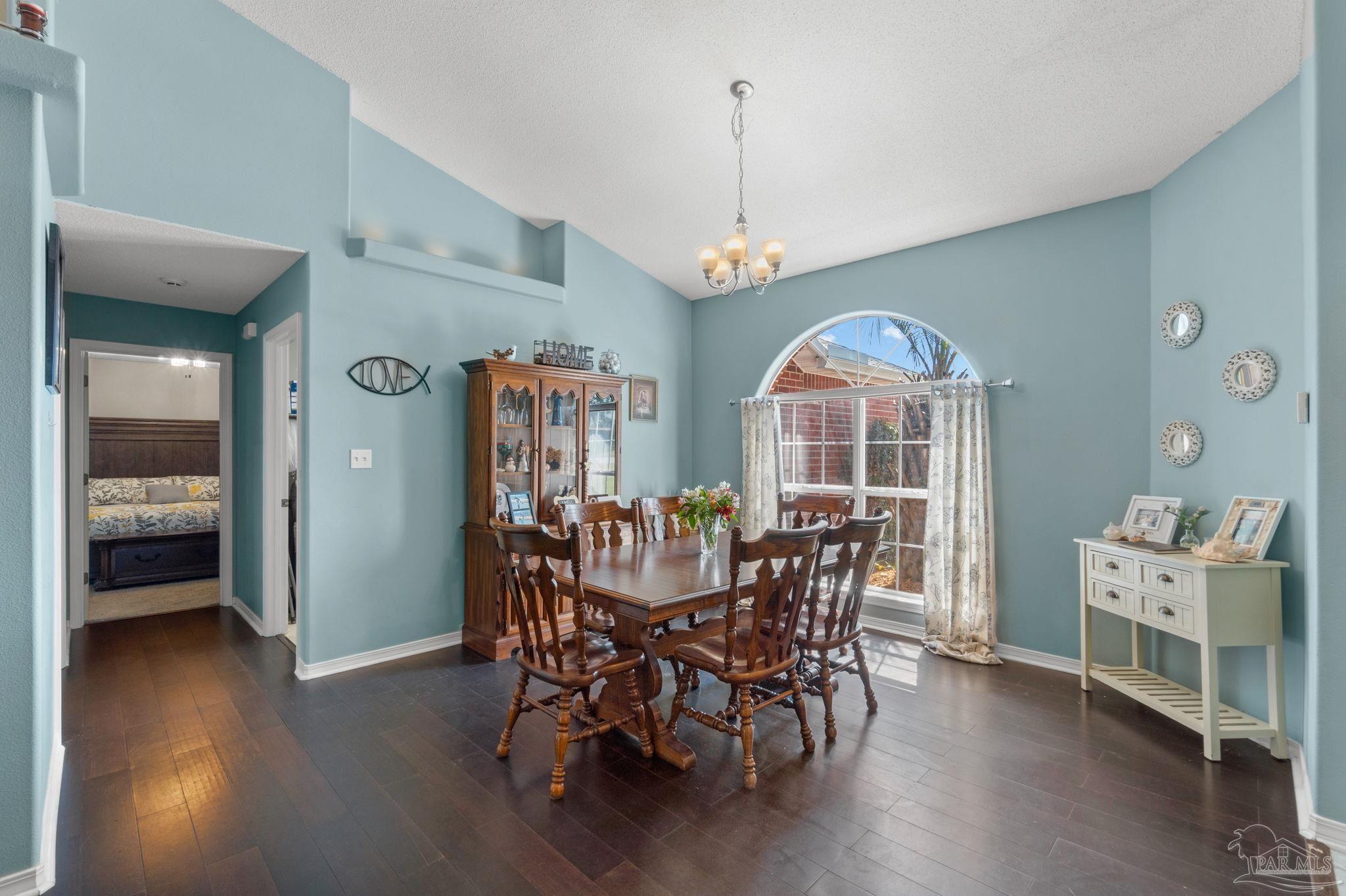 8046 Castle Pointe Way Pensacola, FL 32506 - Photo 15 of 40 a view of a dining room with furniture window and wooden floor