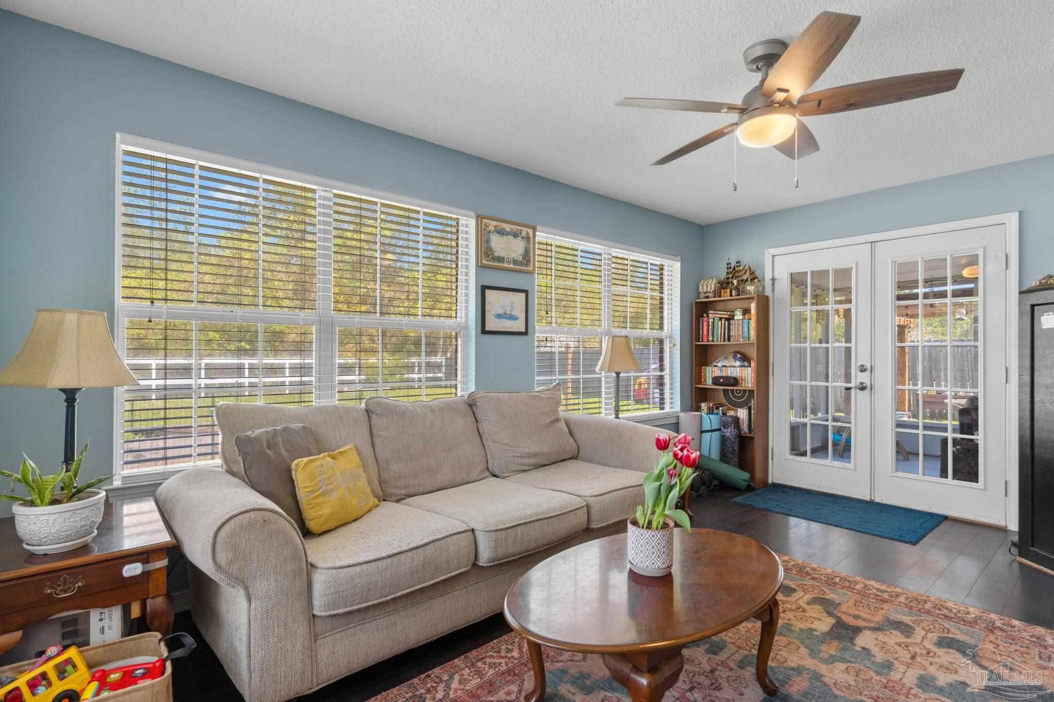 8046 Castle Pointe Way Pensacola, FL 32506 - Photo 17 of 40 a living room with furniture and a large window