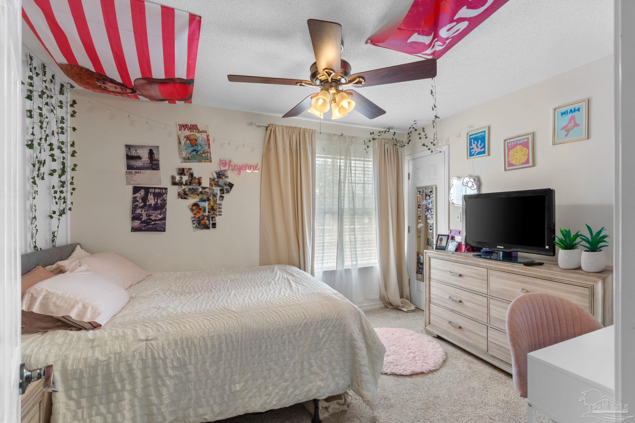 8046 Castle Pointe Way Pensacola, FL 32506 - Photo 18 of 40 a bedroom with a bed and a flat screen tv