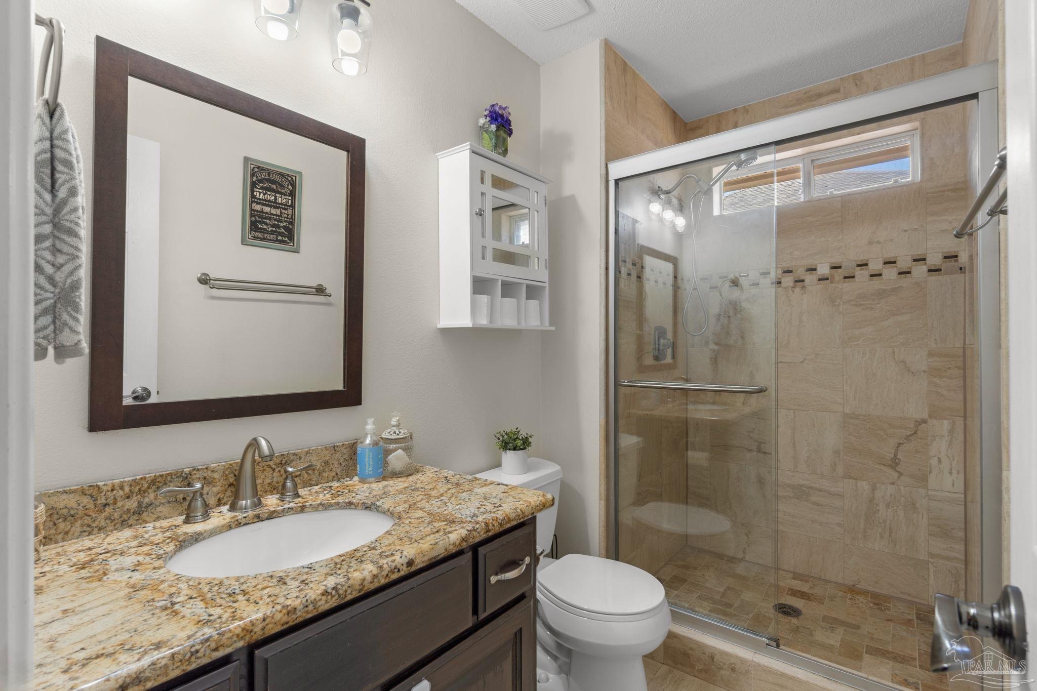 8046 Castle Pointe Way Pensacola, FL 32506 - Photo 20 of 40 a bathroom with a granite countertop sink toilet and shower