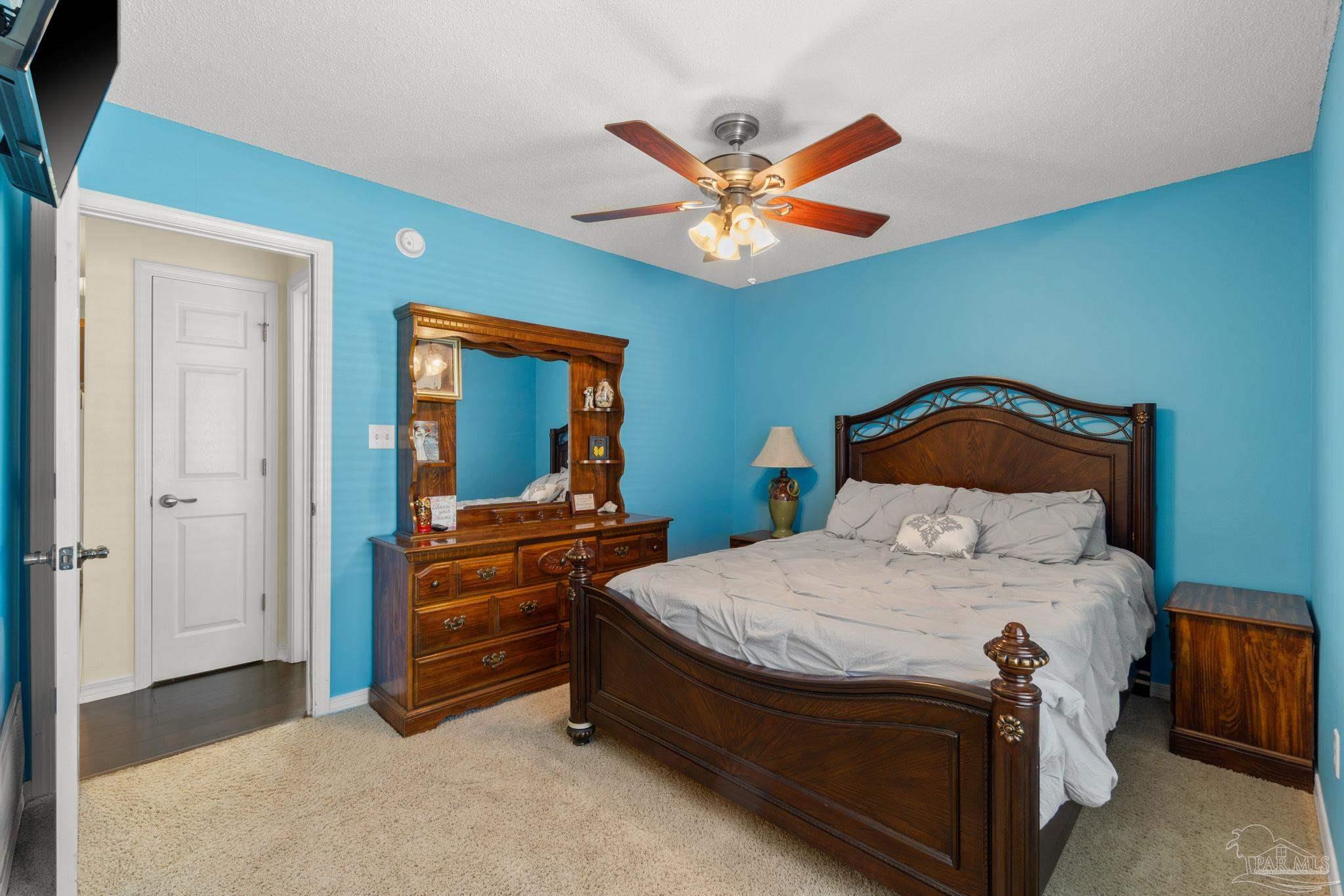 8046 Castle Pointe Way Pensacola, FL 32506 - Photo 21 of 40 a bedroom with a bed and a chandelier