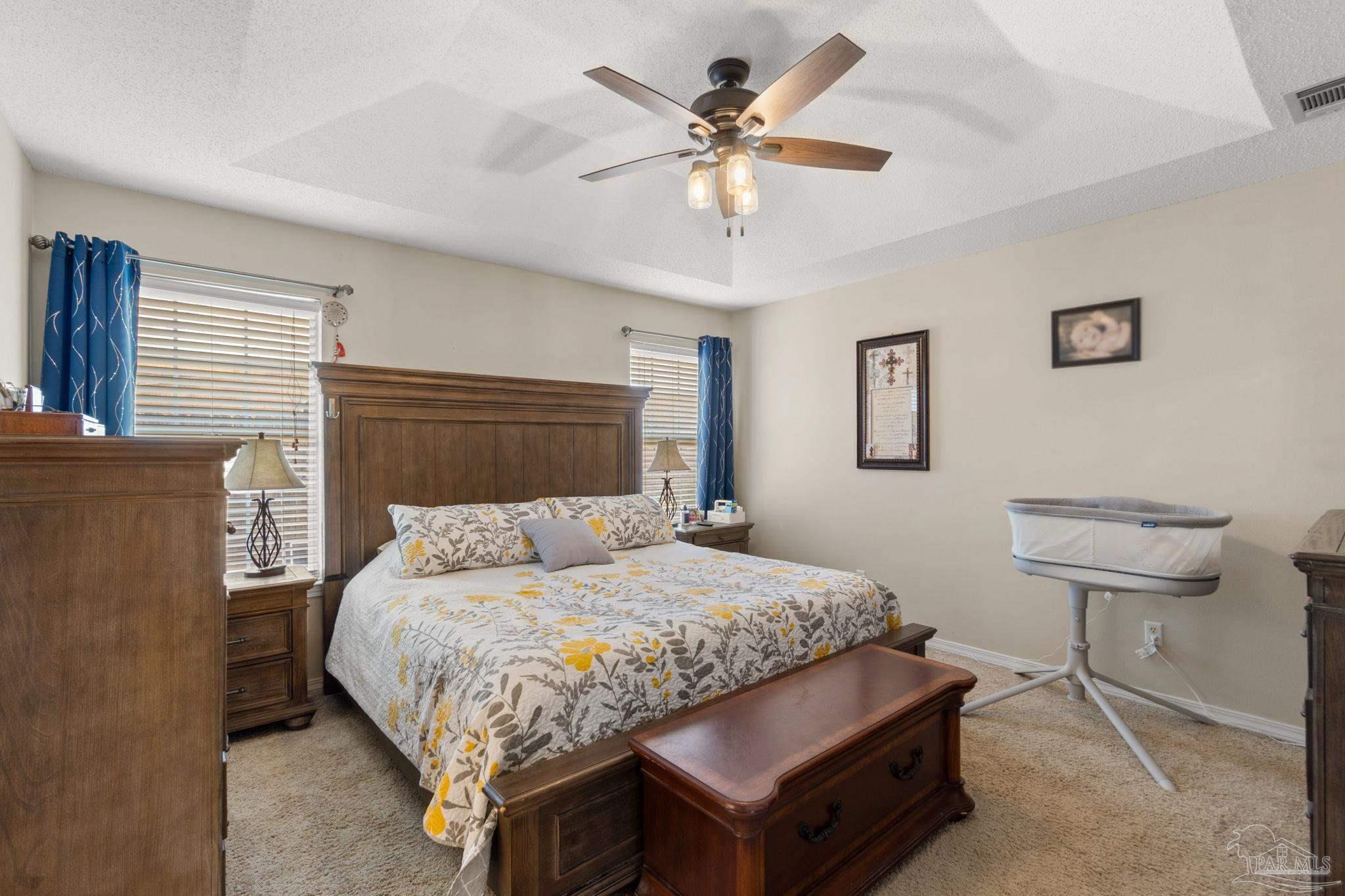 8046 Castle Pointe Way Pensacola, FL 32506 - Photo 22 of 40 a bedroom with a bed and a chandelier