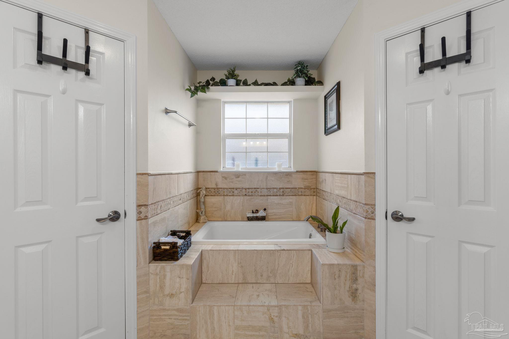 8046 Castle Pointe Way Pensacola, FL 32506 - Photo 24 of 40 a bathroom with a bathtub and shower