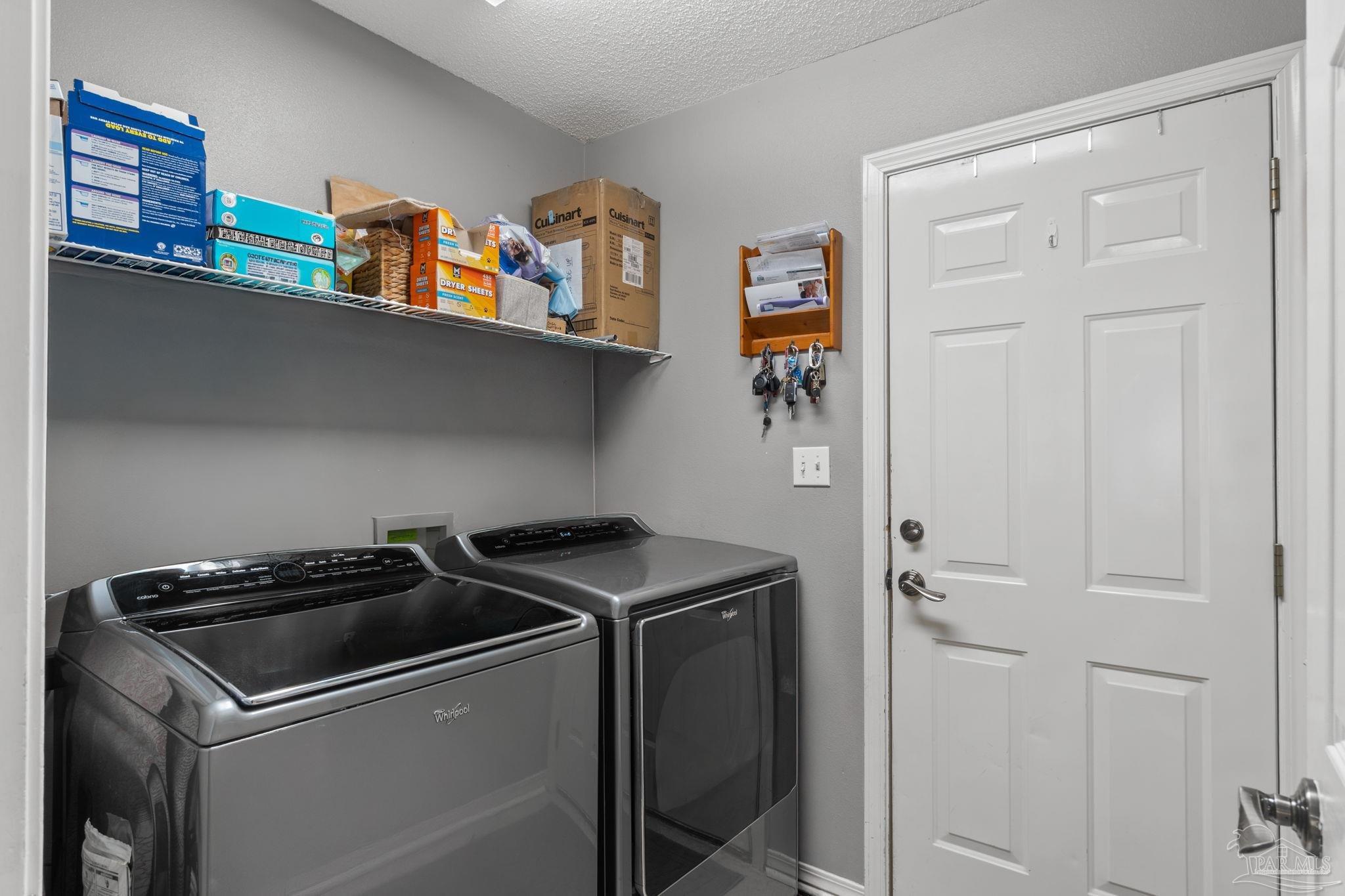 8046 Castle Pointe Way Pensacola, FL 32506 - Photo 26 of 40 a utility room with dryer and washer